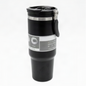 A black vacuum-insulated travel tumbler with a flip-top lid and carrying handle, shown on a plain white background.